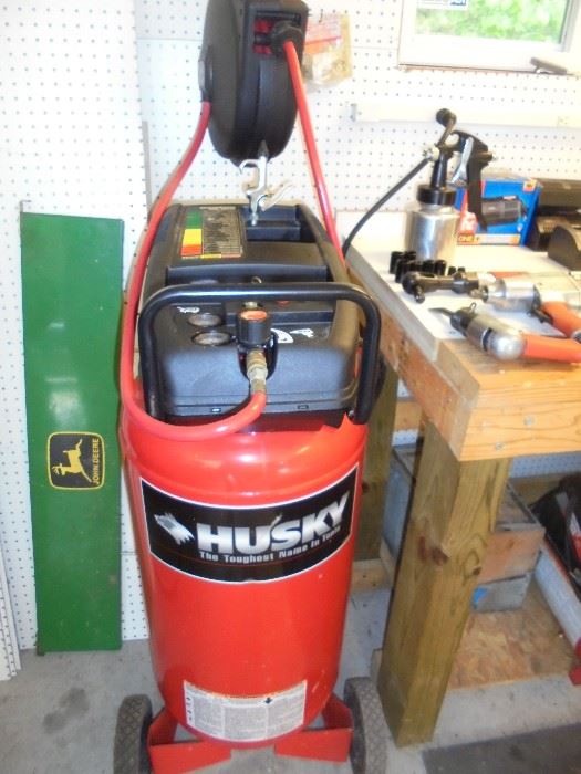 Husky air compressor with a Craftsman retractable hose reel. 