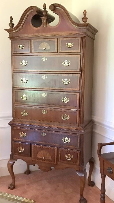 This highboy has a full bonnet top, 11 drawers, beautiful inlay, and ball & claw feet.