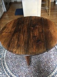 one of a kind, round dining table purchased from Bennett Galleries, made from reclaimed wood
