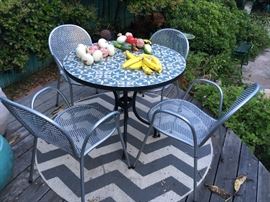 Al Fresco Dining for 4, Any Time of Day; Handmade Tile top, Iron base; Metal-mesh Chairs; Round Outdoor Rug