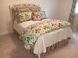 Another beautiful bedroom with plush queen-sized, upholstered headboard and custom bedding.