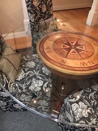 Custom crafted table features compass decorative accents under glass