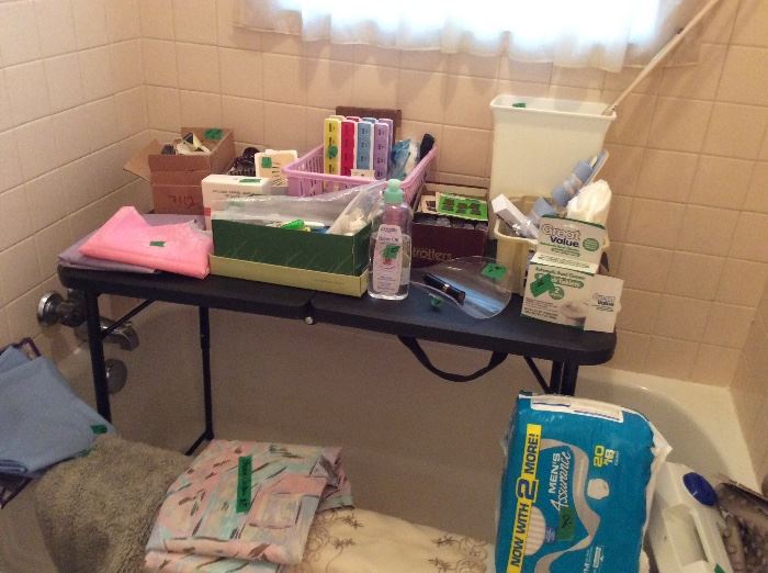 miscellaneous bathroom items including shower curtains, toiletries, bath mat, curlers, portable whirlpool 