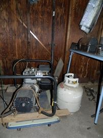Tool Building - generator, butane tank, table full of various items