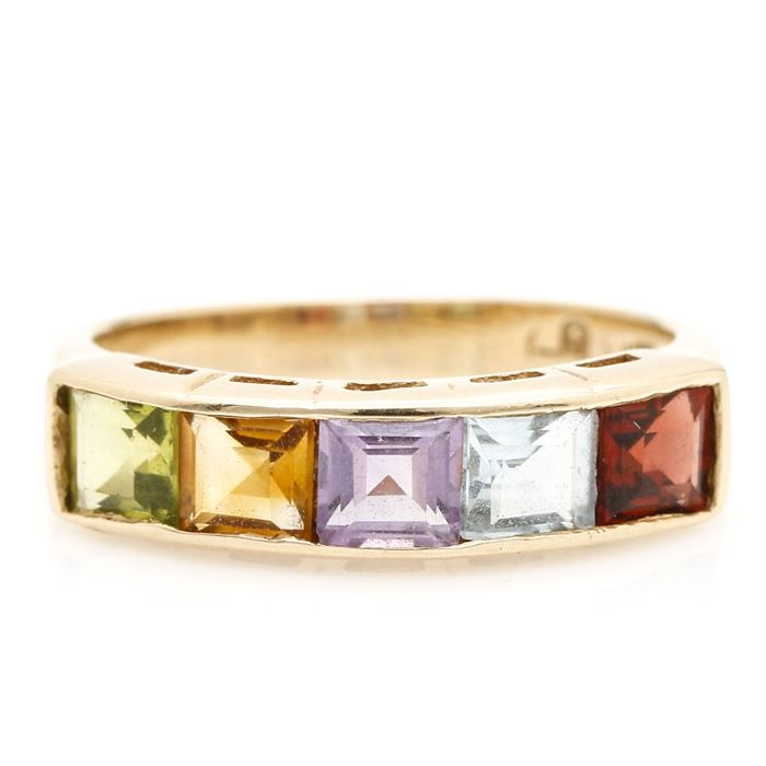 10K Yellow Gold Semi-Precious Stone Ring: A 10K yellow gold ring with a row of channel set semi-precious stones. These stones are located above a pierced gallery leading to smooth, tapered shoulders.