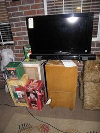 Bravia TV, Itrak Sound Bar w Bluetooth, Christmas items, Record player and cabinet with old records, furry pillows