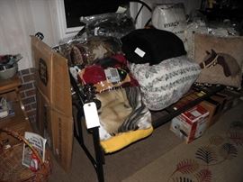 Duvets, covers, furry blankets, black metal day bed, wrapped mirror, horse pillow, steamer