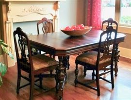 Walnut antique table with hidden leaf and six chairs