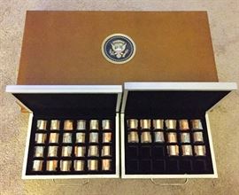 Box set of uncirculated presidential dollar coins is presented in a wood case with presidential seal on top.  Each president represented also has a roll of 12 uncirculated coins.  This makes a total of $13 in coins for each of the 39 presidents represented for a grand total of $507 worth of uncirculated presidential dollar coins.   