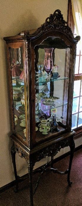  1940's Ornate Curio Cabinet with Glass Shelves and a Mirrored Back