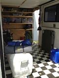 enclosed trailer with shelves and battery with solar power charger.