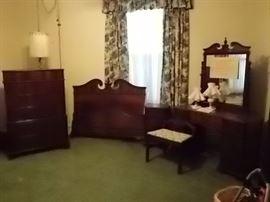 Burled walnut bedroom suite, full size bed with head and foot board, mirrored dresser with vanity and 6 drawer chest.  Bottom drawer of chest is cedar drawer with lid.