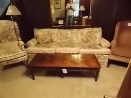 cream sofa with dusty rose flowers, matching chair and 2 contrasting dusty rose wind back chairs.