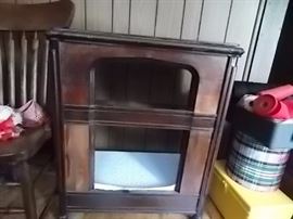 This is an old radio cabinet that has had everything removed from it