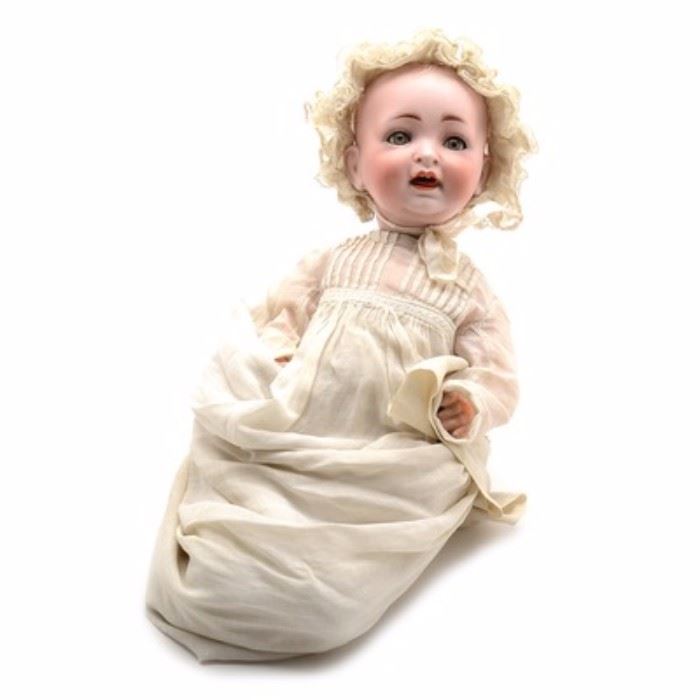 Hertel & Schwab German Bisque Head Baby Doll in Vintage Christening Gown: An antique Hertel & Schwab bisque head baby boy doll dressed in a vintage Christening gown. This young boy features a joyful open mouth expression showing two enameled teeth and grey-blue eyes with lashes. He has a vintage (but modern) wood composite body with painted finger detail and wears a vintage christening gown. His booties are hand knitted. The head is marked to the back of his head “Made in Germany 151/5”.