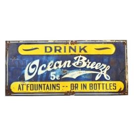 Vintage "Ocean Breeze" Metal Sign: A vintage Ocean Breeze metal sign. The piece is embossed and colored with dark blue, yellow and white. The sign reads “Drink Ocean Breeze 5¢ At Fountains — Or In Bottles” Made by The Scioto Sign Company, Kenton, Ohio.