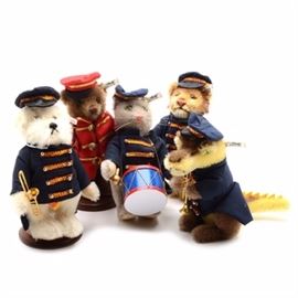 Steiff Circus Band Set of Five Golden Age of the Circus: A complete set of the Steiff Circus Band animals from the Golden Age of the Circus collection. Each German-made mohair animal features a button to their ear with tags and their original hexagon-shaped boxes. This lot includes the bear Bandmaster, the dog Bandsman, the cat bandsman, the lion bandsman, and the crocodile bandsman. Circa 1988.