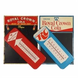 Royal Crown Cola Menu Signs and Thermometers: A collection of vintage Royal Crown Cola metal menu signs and thermometers including two metal menus with chalkboard writing surfaces and RC Cola slogans, and two metal thermometers with Royal Crown Cola logos, in blue and red.