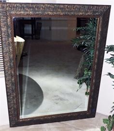 Ornate wood framed wall mirror