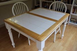Tile top pine kitchen table with four chairs.