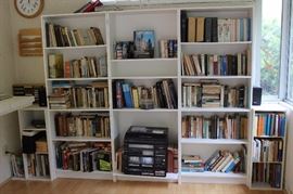 Book shelves full of classics of literature and poetry, cliff notes, book club titles.