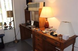 Maple writing desk, computer desk, books and floor lamp.