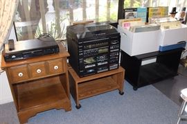 Nightstand, stereo stand, stacking stereo/speakers and turntable, boxes of vinyl LPs. 