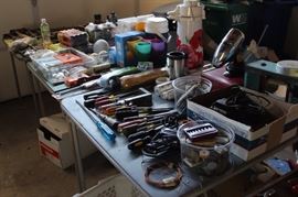 Tables of tools, picnic and camping equipment.