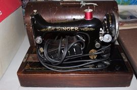 Singer electric sewing machine with case.