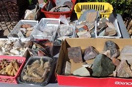 Boxes of stones and geodes for lapidary work. Rock tumbler and other tools.