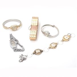 Vintage and Contemporary Wristwatches: An assortment of vintage and contemporary wristwatches. Featuring gold and silver tone metal bands, this selection of five wristwatches include pieces from Bulova, Elgin and Feinbros.