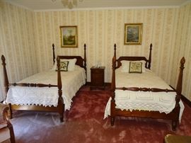 Mahogany four poster twin beds.