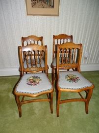 Set of four matching victorian chairs with needlepoint seats.