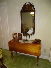 Chippendale mirror, cherry drop leaf table, single student lamp.