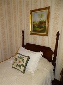 One of two mahogany four poster twin beds.