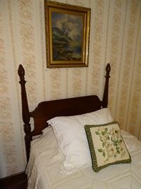 One of two four-poster mahogany twin beds.