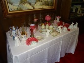 Table of antique miniature oil lamps, lladro, art glass, hand painted china....