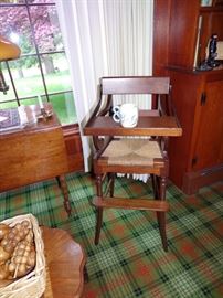 Antique high chair with rush seat.