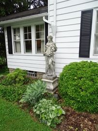 Garden life size statue of autumn maiden.