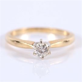 14K Gold Round Brilliant Diamond Solitaire Ring: A 14K yellow gold round brilliant diamond solitaire ring in a six-prong setting.