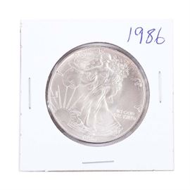 1986 One Dollar U.S. Silver Eagle: A 1986 One Dollar U.S. Silver Eagle. First year of issue. Designer: Adolph A. Weinman/John Mercanti. Mintage: 5,393,005. Metal Content: 99.93% Silver, .007% Copper. Diameter: 40.6 mm. Weight: 31.1 grams.