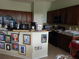 Kitchen full of cookware and bake ware. Art pieces