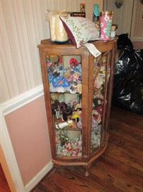 Antique glass front curio filled with collectible figures
