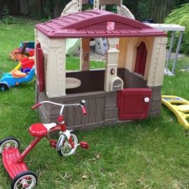 Kid's Playhouse with Radio Flyer Tricycle parked out front