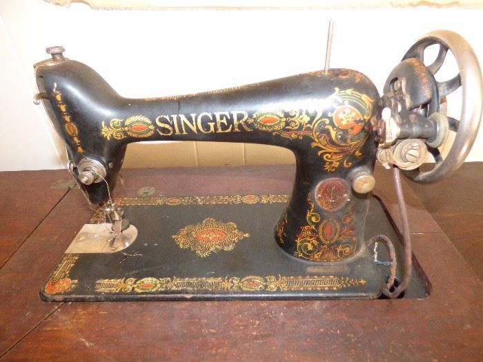 Antique Singer sewing machine inside cabinet