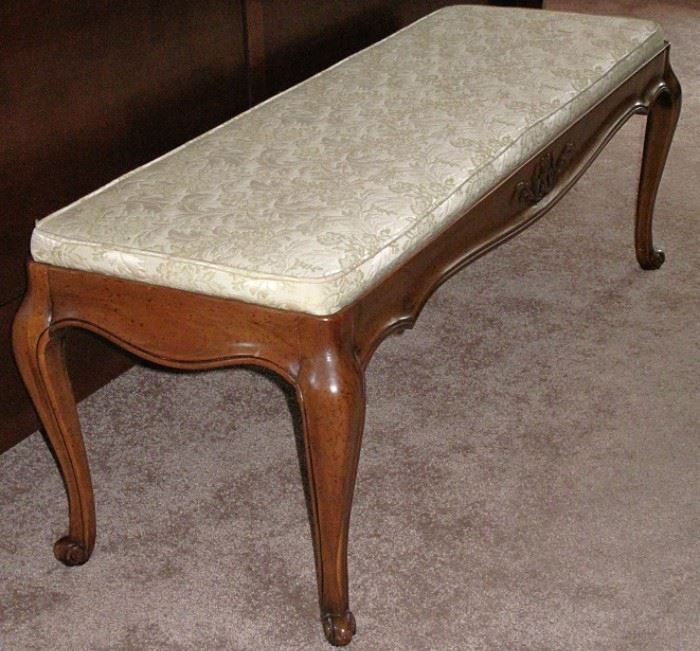 Bench upholstered in beige brocade with cabriole legs.