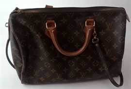 Lot 26. Louis Vuitton Leather Logo Duffel Form Bag