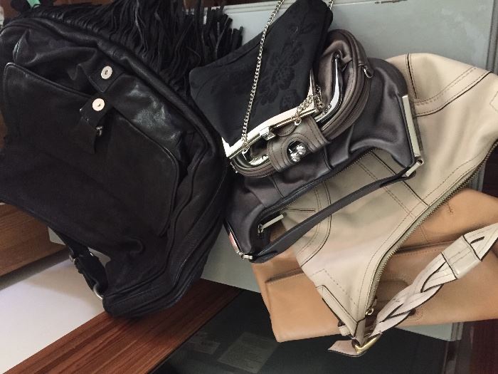 Handbags by Coach, Uno de 50 and more.