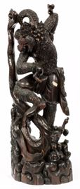 Lot#290, BALI, HAND CARVED IRON WOOD, DEITY, H 30" Depicts an Indonesian Balinese wooden sculpture of the Hindu God Hanuman, dancing with a dragon/serpent.