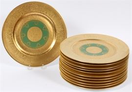 Lot#1021, SET OF TWELVE HENRICH & CO PORCELAIN PLATES, DIA 10 3/4" 20th century. A group of twelve porcelain plates with ornate gilt decoration throughout featuring flora and foliate cartouches, with a green painted center featuring foliate swags. All with green maker's mark to underside.